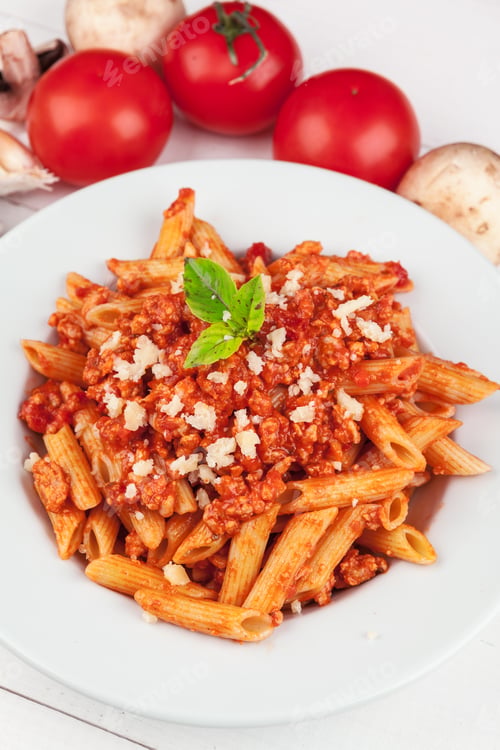 Preview: Pasta with meat, tomato sauce and vegetables on the table