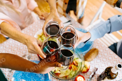 Preview: Group of Friends Enjoying a Festive Home Gathering with Wine and Food