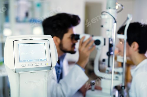 Preview: Optometrist examining patient in modern ophthalmology clinic