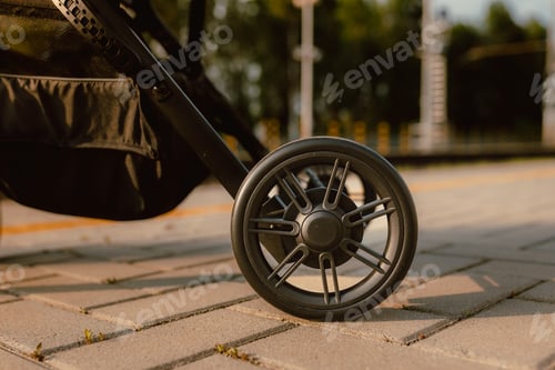 Preview: Detail of stroller wheels at the train station at sunset.CR2