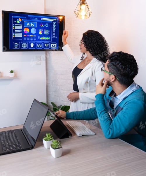 Preview: A professional presenting advertising data and growth metrics on screen during a corporate meeting