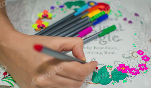 Preview: The hand of teenagers while drawing using colorful markers