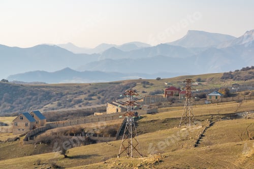 Preview: Power transmission towers in a mountain valley