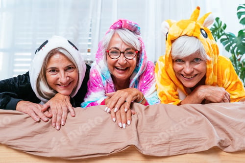 Preview: Beautiful senior women having funny pajama party at home