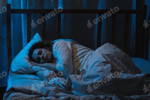 Preview: Insomnia. Woman lying awake in bed at night.