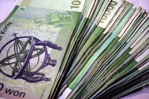 Preview: Closeup of 10 000 Korean won bills spread out background