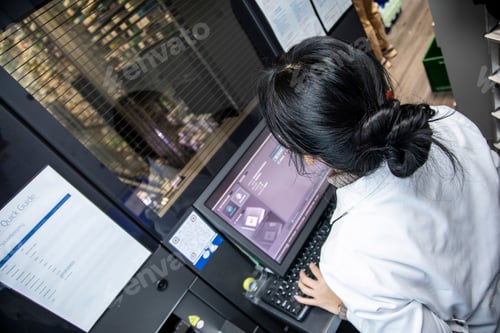 Preview: Woman working on a modern medical device with monitor and keyboard