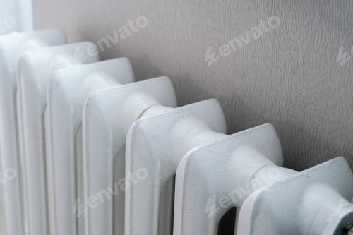 Preview: an old vintage metal white heating battery at home apartment