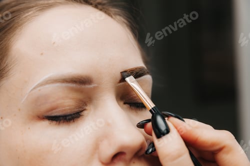Preview: girl doing eyebrow microblading. applying eyebrow paint. facial skin care. lip augmentation
