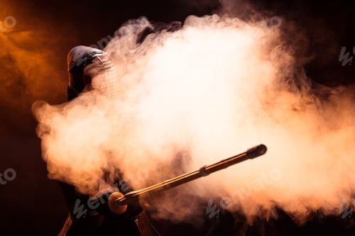 Preview: Kendo fighter in helmet holding bamboo sword in smoke