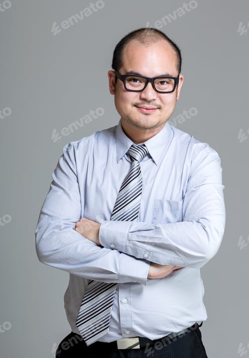 Professional Man with Arms Crossed in Business Attire