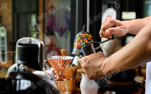 Preview: Barista grinding coffee beans for drip brew