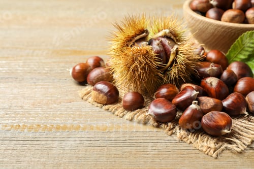 Preview: Fresh sweet edible chestnuts on wooden table