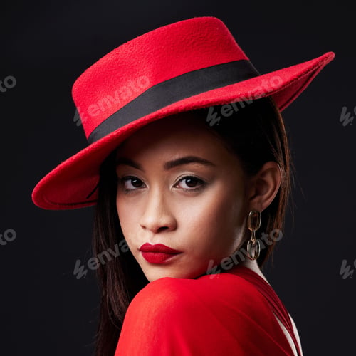 Preview: Portrait, red and fashion with a woman on a dark background in studio for contemporary style. Face,