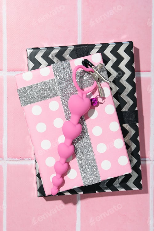 Preview: Sex toys with Christmas gifts on the background.