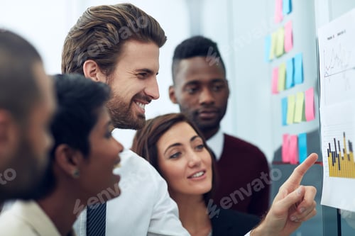 Preview: Cropped shot of a group of colleagues working at the idea board