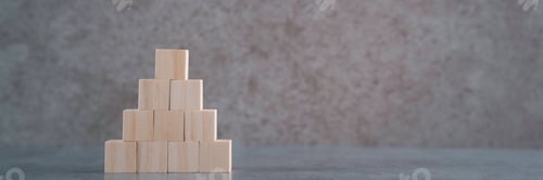 Preview: Close-Up Of Wooden Toy Blocks On Table Against Wall with copy space