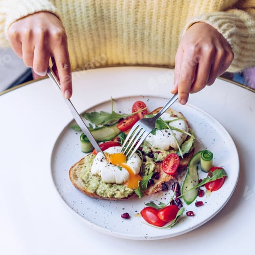 Preview: Woman is enjoying her brunch in cafe.