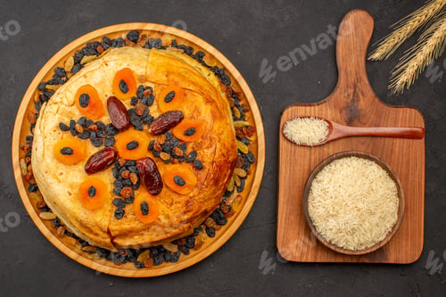 Preview: top view shakh plov delicious rice meal cooked inside round dough with raisins on grey background