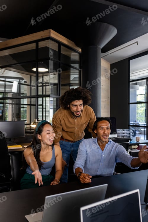 Preview: Collaborating on project, diverse team using laptops and discussing ideas in office