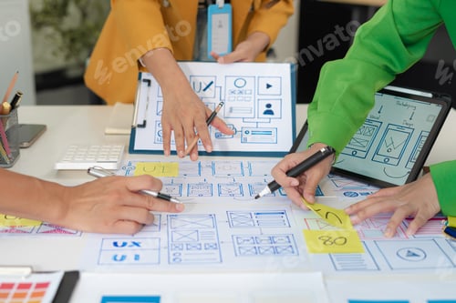 Preview: developer team brainstorming on their project with laptop, smartphone and digital tablet.