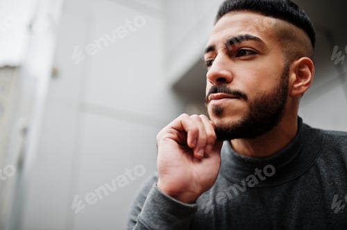 Preview: Portrait of stylish arab beard man wear grey turtleneck. Arabian model guy against steel wall.