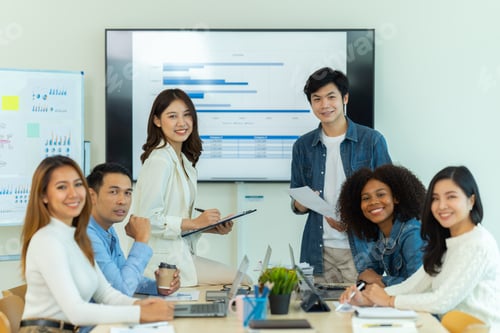Preview: Business people showing team work while working in board room in office interior.