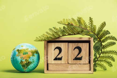 Preview: wooden calendar with date '22 april' and green fern leaf on light green background