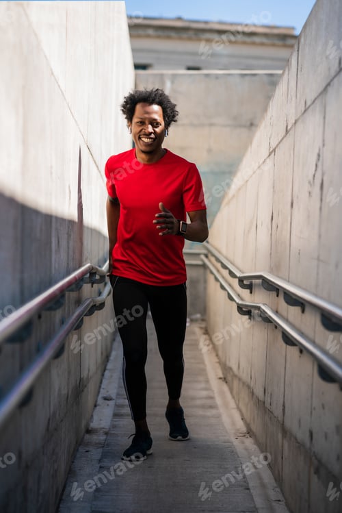 Preview: Athletic man running and doing exercise outdoors.
