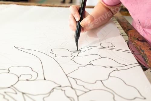 Vista previa: Artist creating detailed floral patterns with black marker on white fabric canvas, batik