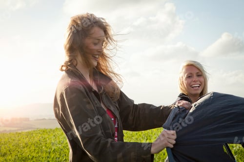 Preview: Two friends sharing a joyous moment outdoors