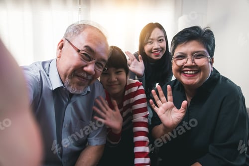 Preview: Close up portrait of big Asian family at home make selfie together