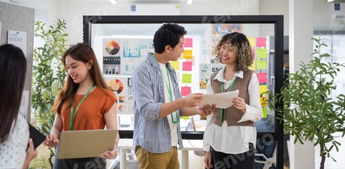 Preview: Group of young Asian business people team meeting in modern office working