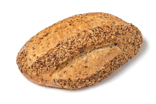 Preview: Fresh whole loaf country breadcovered with seeds close up on white background