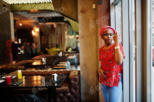 Preview: Stylish african woman in red shirt and hat