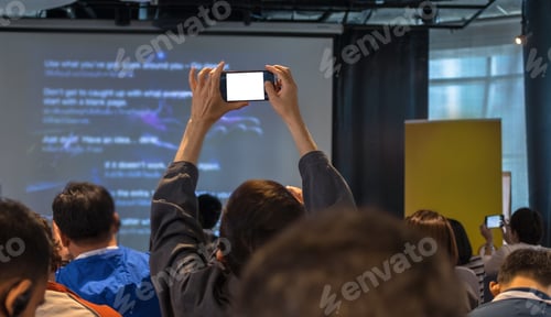 Preview: Closeup some attendee taking the photo the presentation in conference hall or seminar room