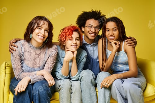 Preview: Vibrant diverse group lounging atop a yellow couch