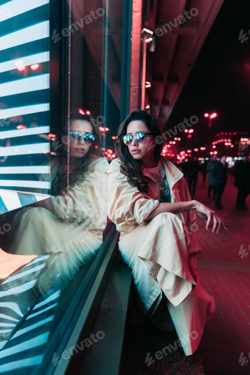 Preview: Night in the city, beautiful woman among red lights