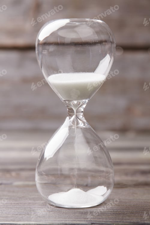 Preview: Close-up hourglass with white sand.