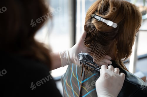 Preview: woman client person having a process to making treatment a hair with hairdresser in beauty salon
