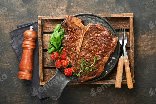 Preview: Steaks T-bone. Sliced beef grilled T-bone or porterhouse meat steak with spices rosemary and pepper