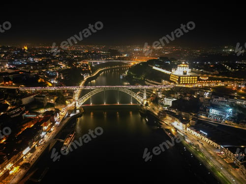 Preview: Aerial view of Ponte Luis I Bridge spanning a river at night