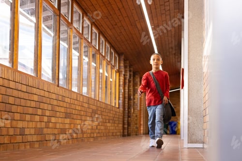 Preview: Walking in school hallway, boy carrying bag and wearing red shirt