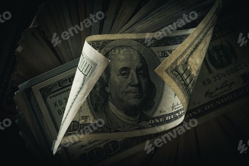 Preview: close up view of dollar banknotes lying on dark background