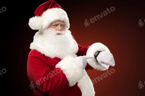 Preview: Santa Claus pointing on smart-watch, christmas coming