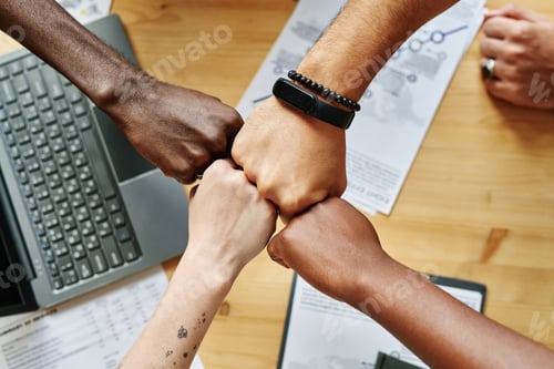 Preview: Above angle of four hands of young intercultural employees