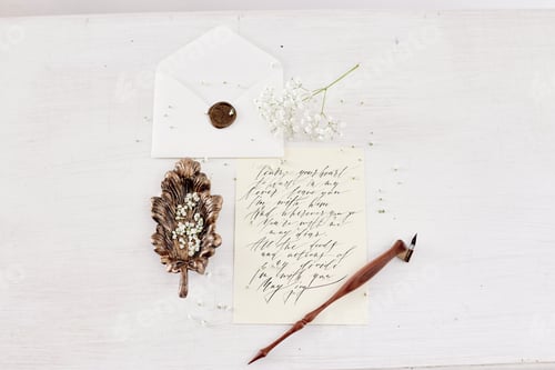 Preview: Girl writes a letter to her beloved man, sitting at home at table in a white light dress, purity and