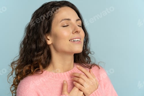 Preview: Thankful young woman with closed eyes smiling thanking god, breathes fresh air, show faith and love.
