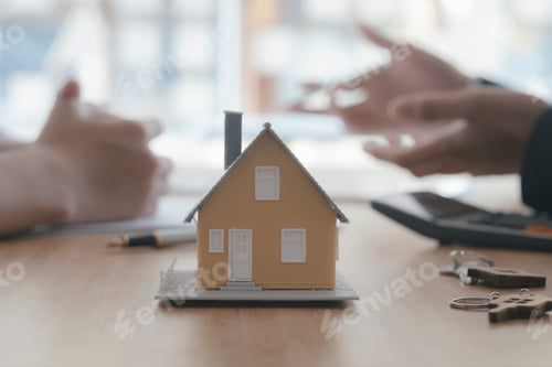 Preview: Close up house model on blur background of real estate agent and customer