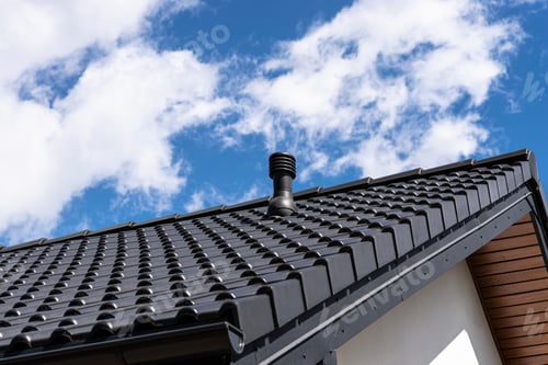 Preview: Building roof showing ventilation pipe on black tiles